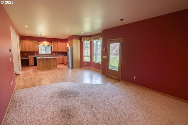 1317 Riggleman Ln, White Salmon, WA 98672 - kitchen featuring freestanding refrigerator, open floor plan, a sink, a kitchen island, and dishwasher
