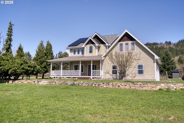 1317 Riggleman Ln, White Salmon, WA 98672 - view of front facade featuring covered porch, a front yard, and solar panels