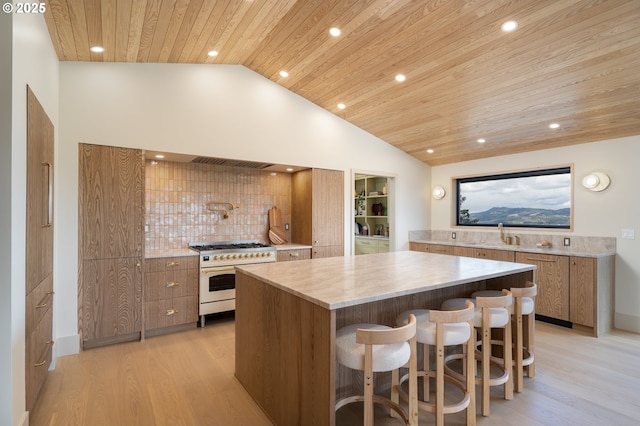 11625 NE Hoskins Hill Rd, Newberg, OR 97132 - kitchen featuring gas stove, wooden ceiling, a kitchen island, light wood-style flooring, and a sink