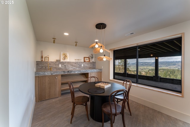 11625 NE Hoskins Hill Rd, Newberg, OR 97132 - dining room with wet bar, baseboards, and wood finished floors