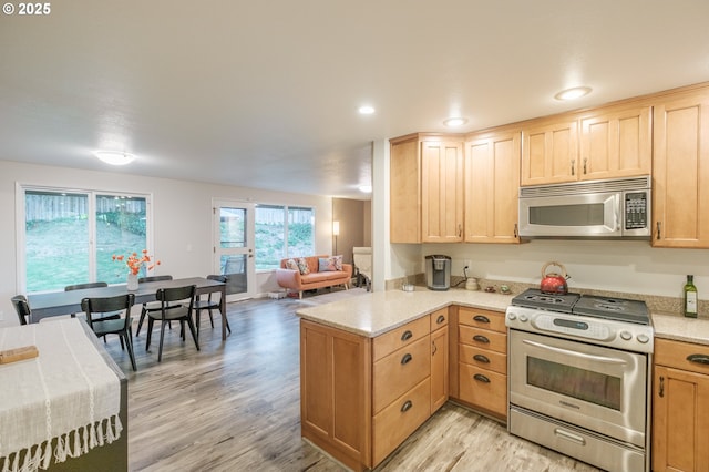 3727 NW Arrowood Cir, Corvallis, OR 97330 - kitchen with stainless steel appliances, light brown cabinetry, light wood finished floors, a peninsula, and recessed lighting
