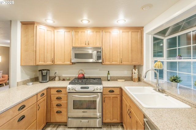 3727 NW Arrowood Cir, Corvallis, OR 97330 - kitchen featuring appliances with stainless steel finishes, a sink, light brown cabinets, and light stone counters