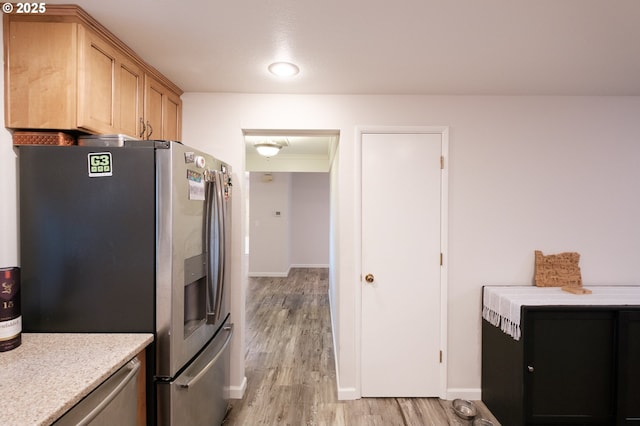 3727 NW Arrowood Cir, Corvallis, OR 97330 - kitchen featuring stainless steel refrigerator with ice dispenser, light countertops, light wood-style floors, and baseboards