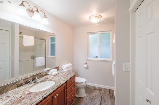 3727 NW Arrowood Cir, Corvallis, OR 97330 - full bathroom featuring wood finished floors, a stall shower, vanity, toilet, and baseboards