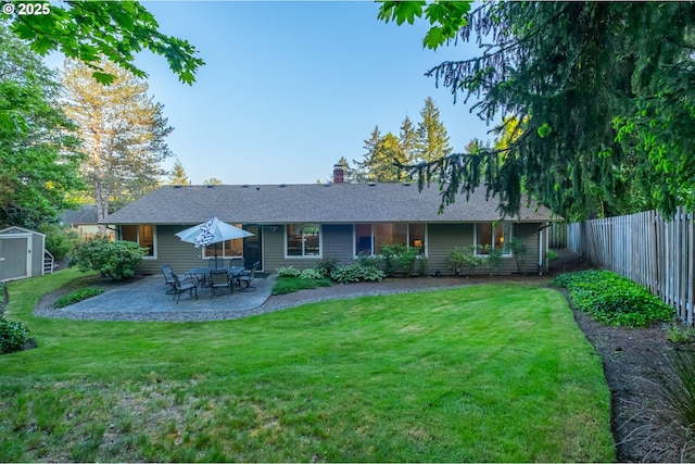 3727 NW Arrowood Cir, Corvallis, OR 97330 - rear view of property with a storage unit, a patio, an outbuilding, a chimney, and a shingled roof