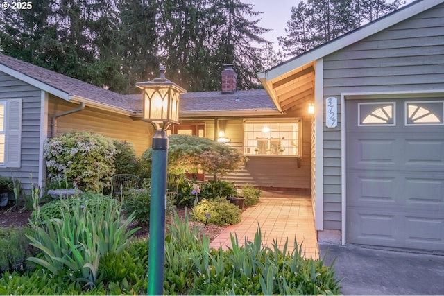 3727 NW Arrowood Cir, Corvallis, OR 97330 - property entrance with an attached garage and a chimney