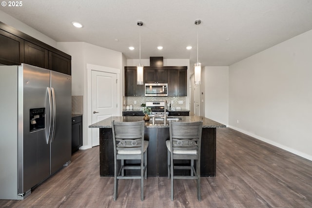 2360 N R St, Washougal, WA 98671 - kitchen with appliances with stainless steel finishes, dark wood-style floors, backsplash, dark stone countertops, and recessed lighting