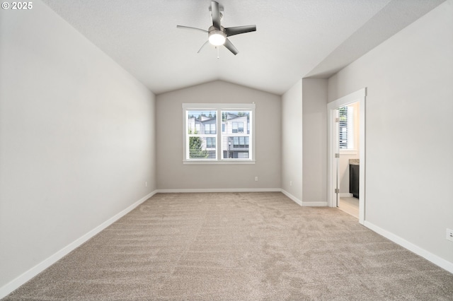 2360 N R St, Washougal, WA 98671 - unfurnished bedroom with multiple windows, light colored carpet, lofted ceiling, connected bathroom, and a ceiling fan