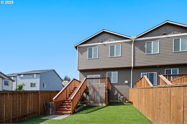 2360 N R St, Washougal, WA 98671 - rear view of house with board and batten siding, a fenced backyard, stairs, and a deck