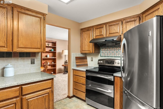 kitchen featuring under cabinet range hood, stainless steel appliances, backsplash, and brown cabinetry