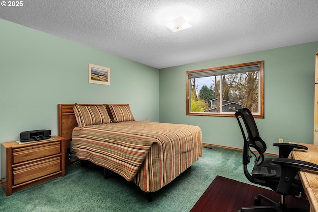 carpeted bedroom with a textured ceiling and baseboards