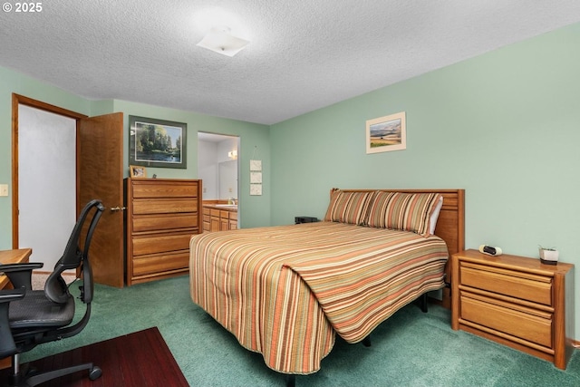 carpeted bedroom featuring a textured ceiling and connected bathroom