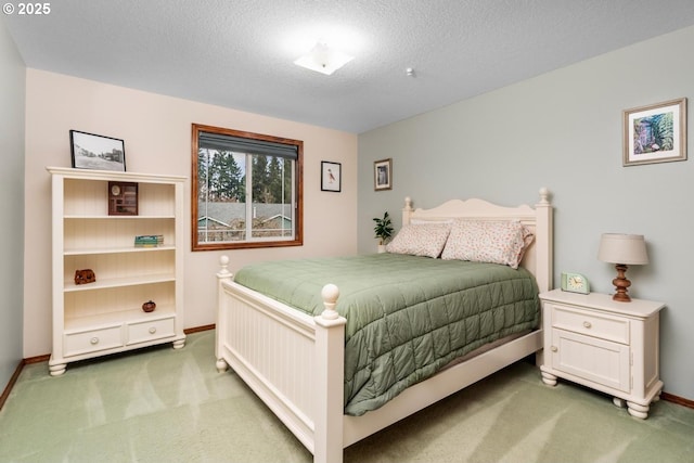 carpeted bedroom featuring baseboards and a textured ceiling