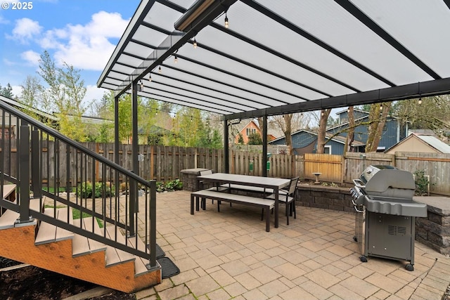 view of patio with outdoor dining area, a fenced backyard, a pergola, and a grill