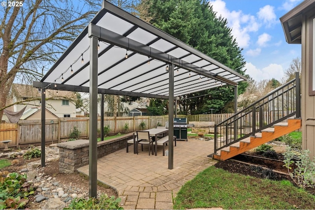 view of patio / terrace featuring stairway, area for grilling, outdoor dining area, a fenced backyard, and a pergola