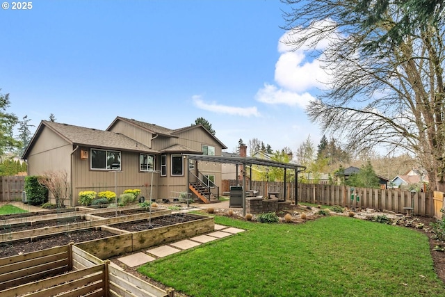 view of yard with a vegetable garden and a fenced backyard