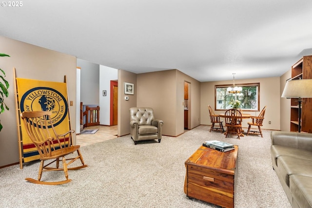 carpeted living room featuring baseboards and a chandelier