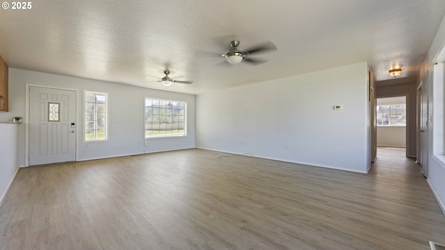 151 E Date St, Powers, OR 97466 - unfurnished living room with wood finished floors, a ceiling fan, and baseboards