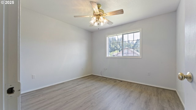 151 E Date St, Powers, OR 97466 - empty room with wood finished floors, ceiling fan, and baseboards