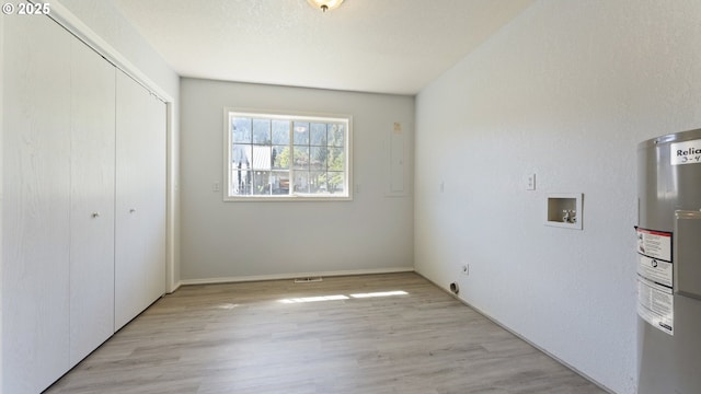151 E Date St, Powers, OR 97466 - unfurnished bedroom with water heater, light wood finished floors, and a closet