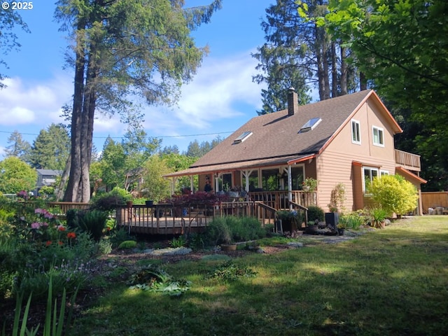 9655 8th St, Bay City, OR 97107 - rear view of house with a chimney, a lawn, a wooden deck, and roof with shingles
