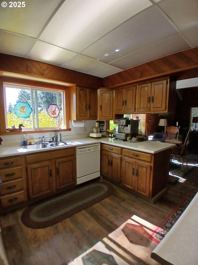 9655 8th St, Bay City, OR 97107 - kitchen with dishwasher, light countertops, brown cabinets, dark wood-style floors, and wood walls