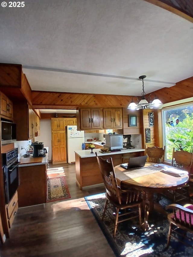 9655 8th St, Bay City, OR 97107 - dining area featuring dark wood-style floors and a chandelier