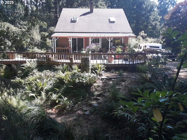 9655 8th St, Bay City, OR 97107 - rear view of house with roof with shingles, a deck, and a chimney