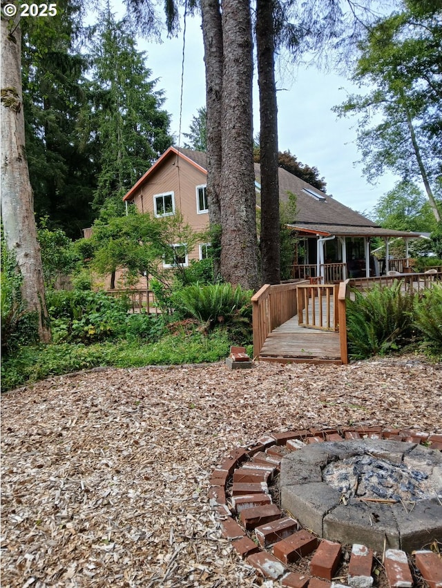 9655 8th St, Bay City, OR 97107 - back of property with a fire pit and a wooden deck
