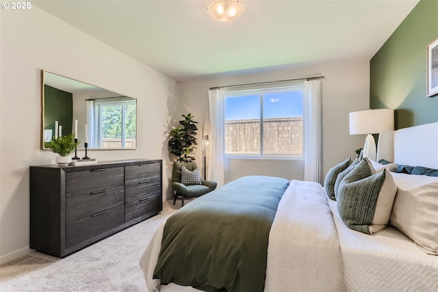 bedroom with baseboards and light carpet