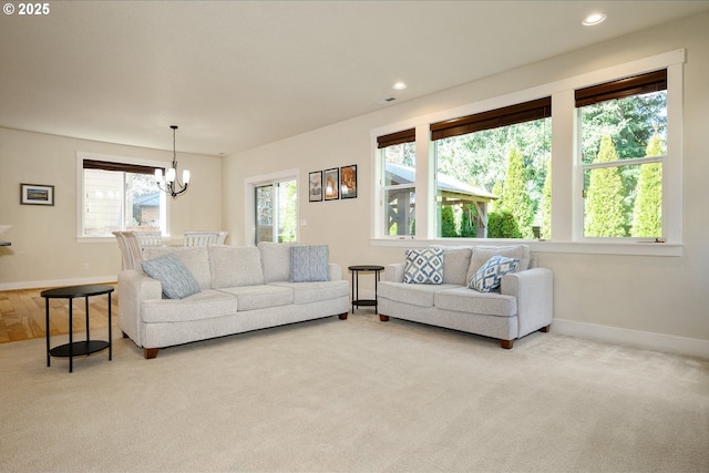 living room with carpet floors, baseboards, a notable chandelier, and recessed lighting