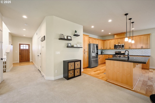 kitchen with light colored carpet, an island with sink, stainless steel appliances, backsplash, and recessed lighting