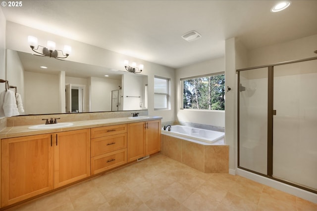 bathroom featuring double vanity, a garden tub, a shower stall, and a sink