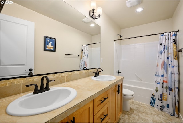 bathroom with a sink, shower / bathtub combination with curtain, toilet, and double vanity