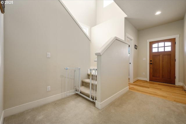 carpeted entrance foyer featuring stairs, recessed lighting, and baseboards