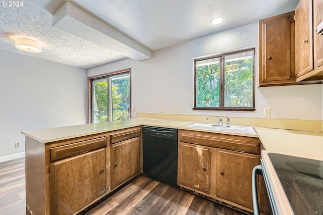kitchen with dark wood-style flooring, a peninsula, dishwasher, and range