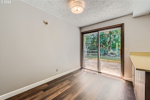 interior space featuring baseboards, dark wood-style flooring, and visible vents