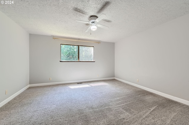 unfurnished room with baseboards, a ceiling fan, a textured ceiling, and carpet flooring