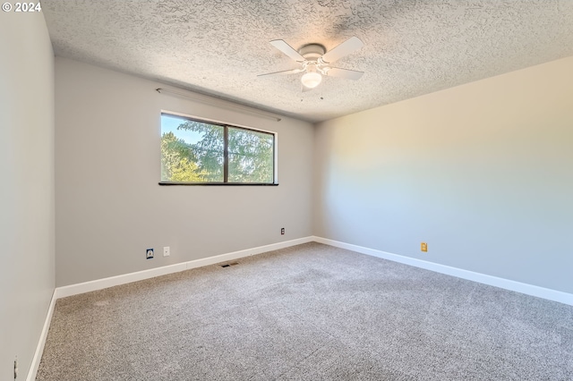 empty room with visible vents, a textured ceiling, ceiling fan, and carpet floors