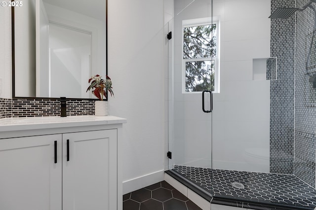 bathroom with an enclosed shower, vanity, decorative backsplash, and tile patterned floors