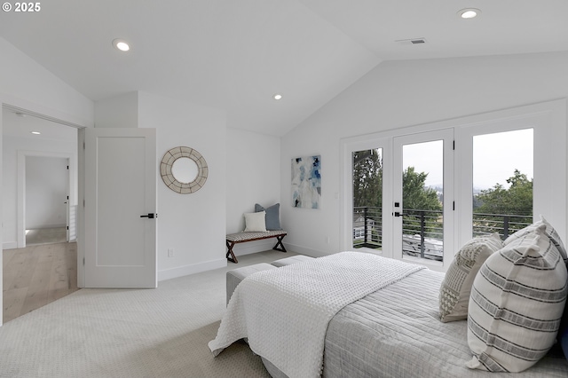 carpeted bedroom with french doors, lofted ceiling, and access to exterior