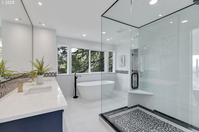 bathroom with tile patterned flooring, vanity, and separate shower and tub