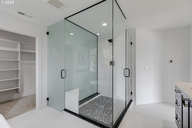 bathroom featuring an enclosed shower, vanity, and tile patterned flooring