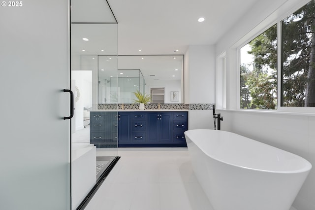 bathroom with tile patterned floors, vanity, and separate shower and tub