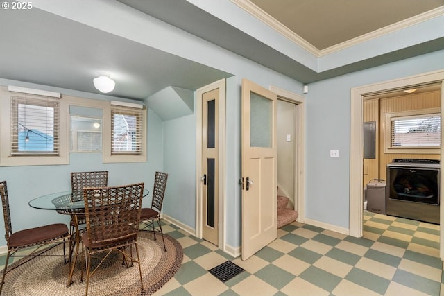 dining room featuring plenty of natural light, crown molding, and washer / dryer