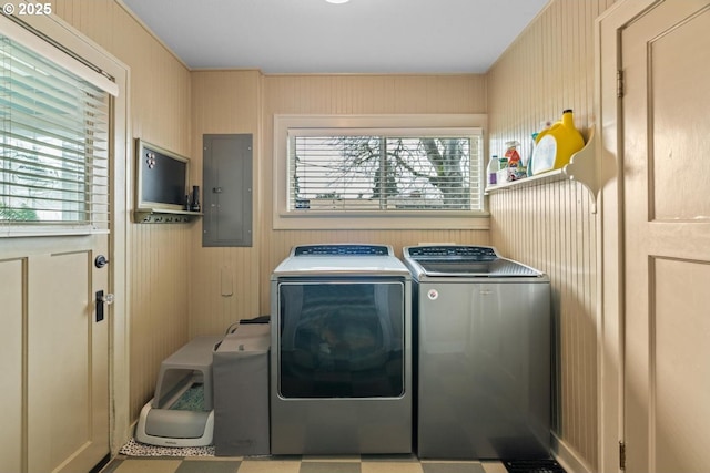 clothes washing area featuring electric panel and washing machine and clothes dryer