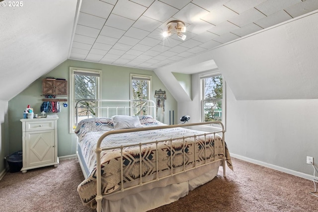 bedroom featuring carpet floors, multiple windows, and lofted ceiling