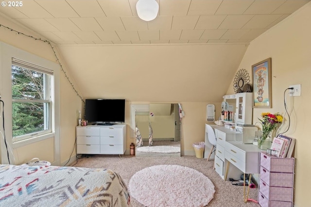 carpeted bedroom with lofted ceiling