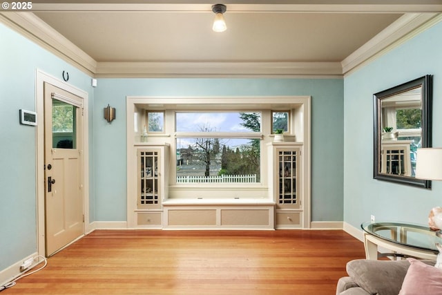 doorway featuring light wood-type flooring and ornamental molding