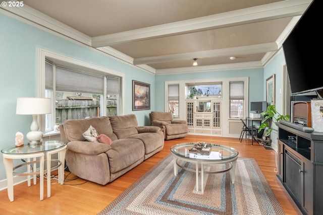 living room with beam ceiling, light wood-type flooring, and crown molding